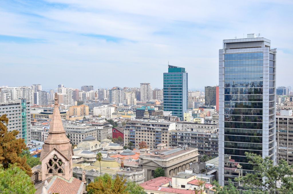 Aerial view of Santiago showcasing modern skyscrapers and historic buildings, a blend of architecture.