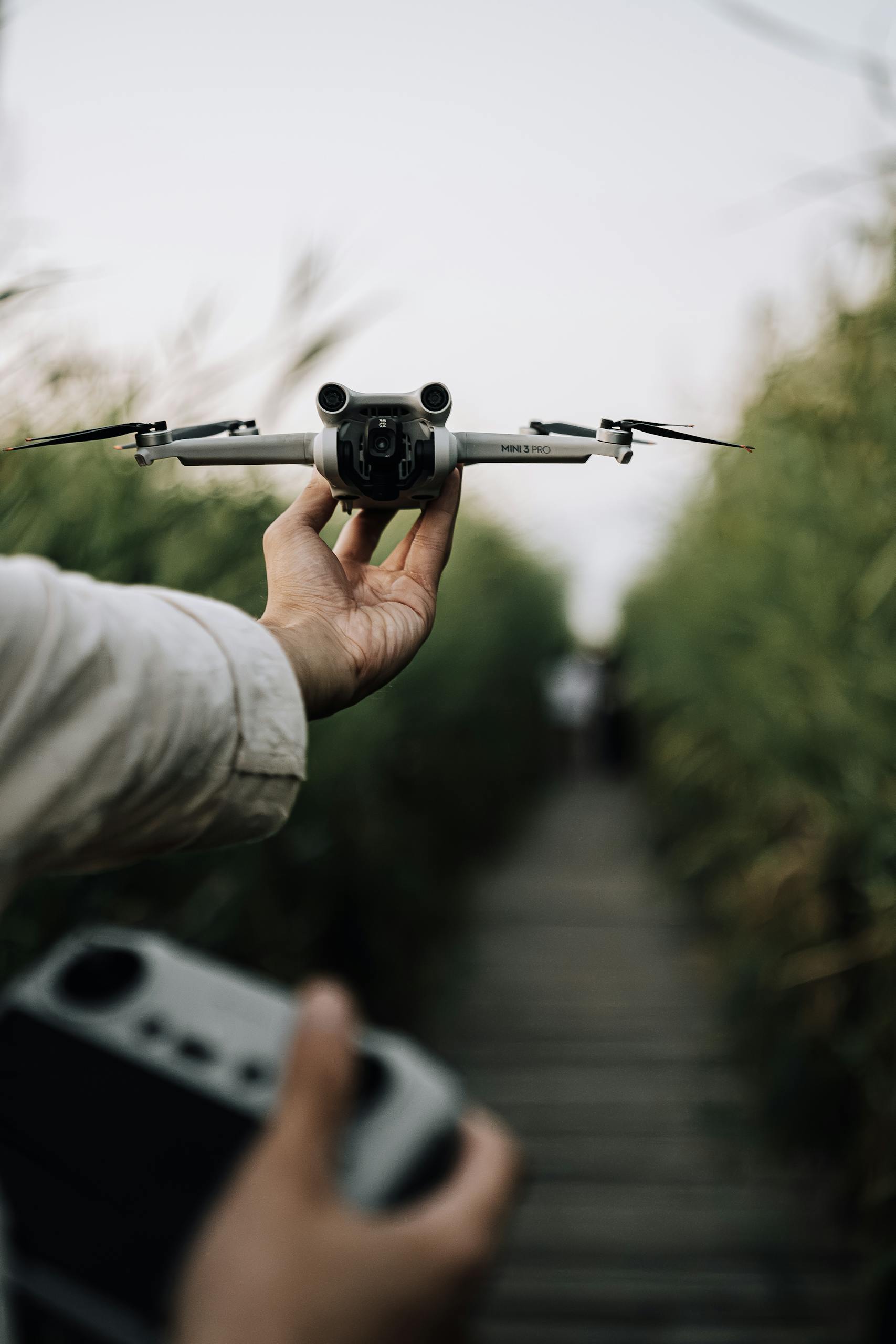 Close-up of a person holding a drone outdoors, showcasing technology and exploration.