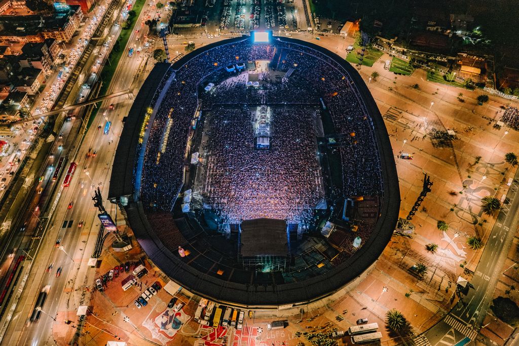Vibrant aerial view of a crowded nighttime concert at Bogotá stadium, Colombia.